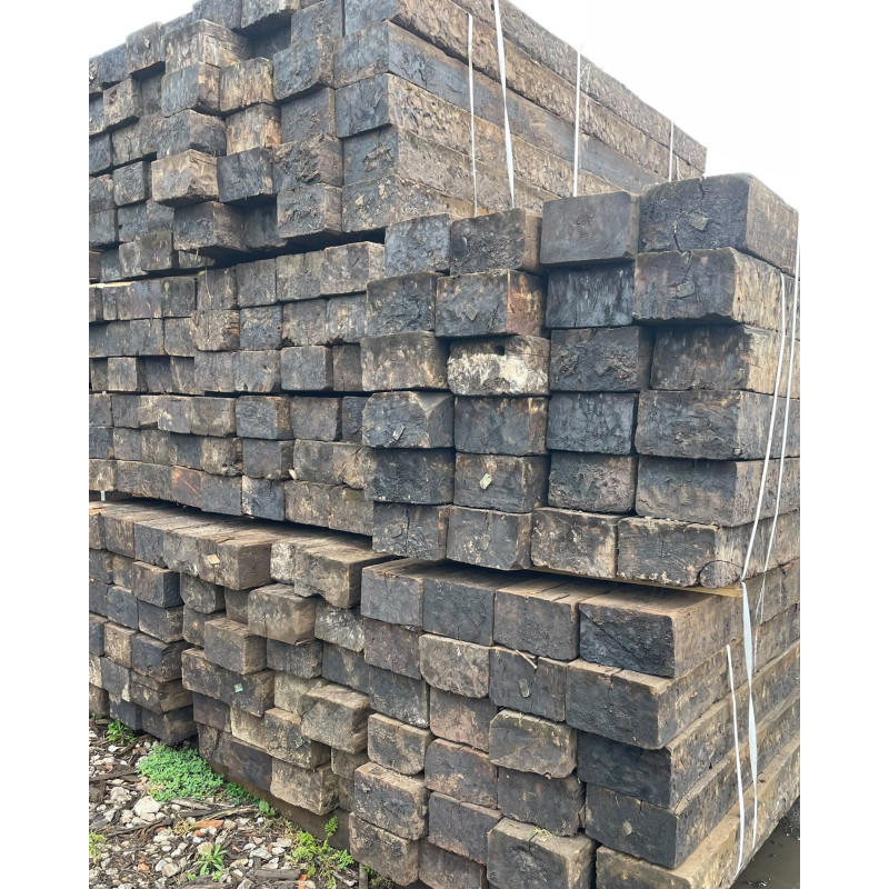 Large stack of purified reclaimed railway sleepers in strapped bundles